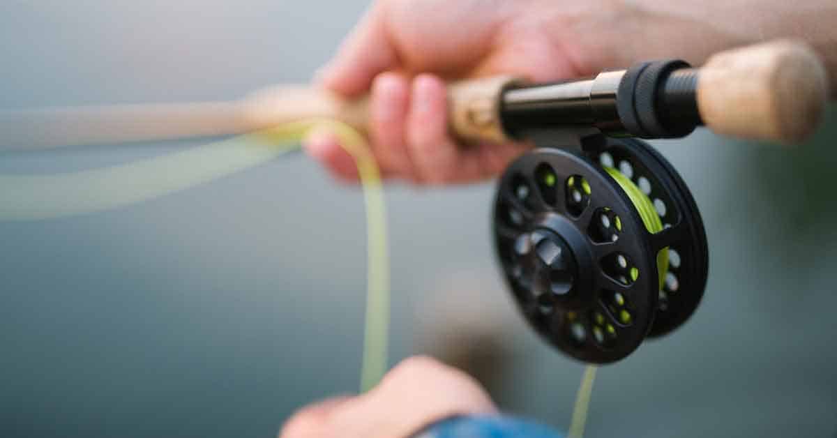 Proper fly fishing hand placement when learning to cast with a fly rod and reel.
