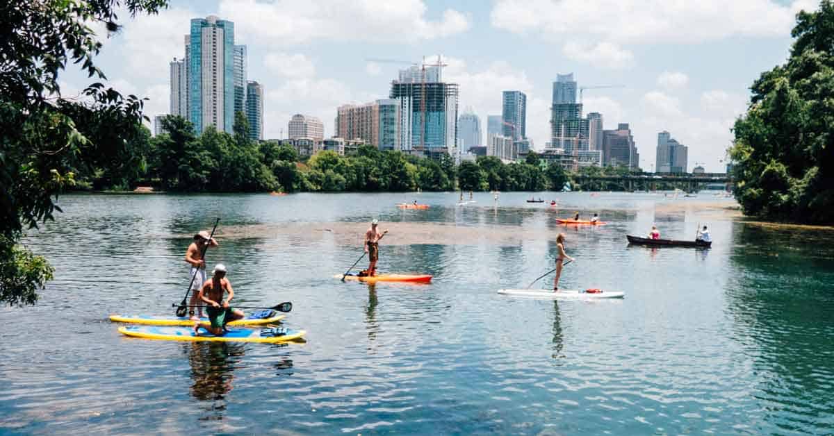 Paddle boarders on the water at Lou Neff Point, Austin, TX.