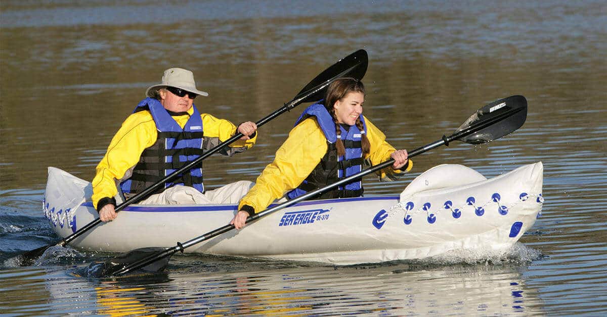 Kayakers tandem paddling a Sea Eagle 370 Sport inflatable 2-person kayak.