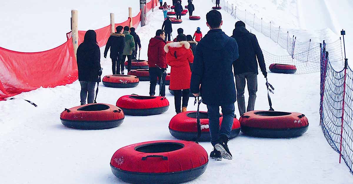 People sledding with heavy-duty snow tubes.