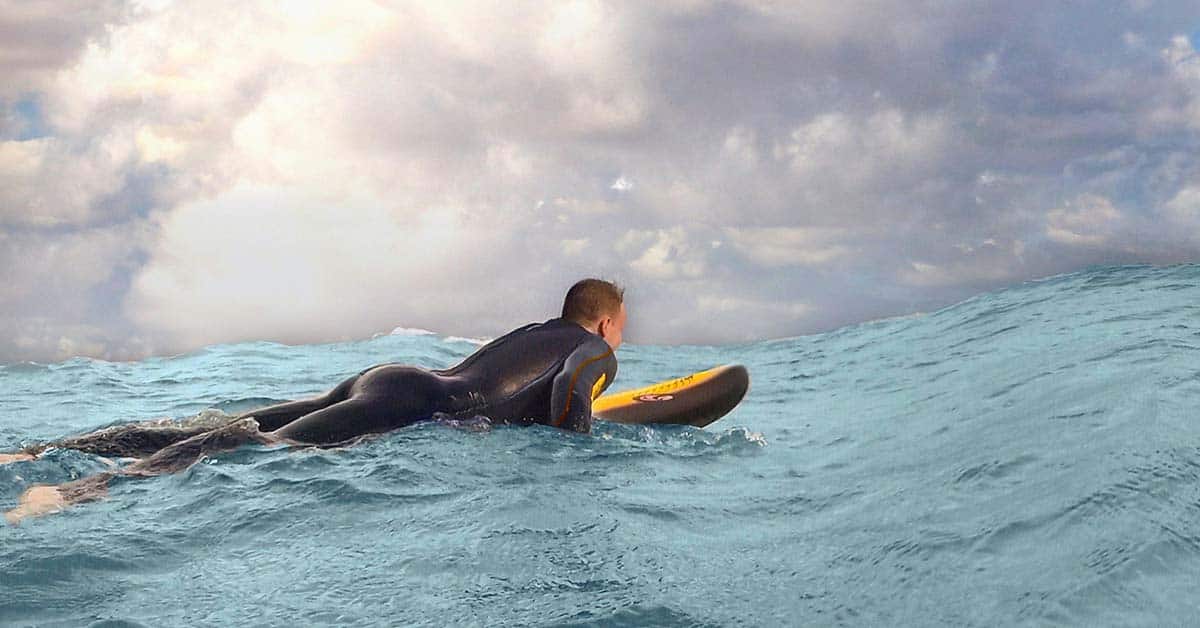 Wetsuit rash can be prevented by choosing the right wetsuit for your water sport. Surfing wetsuits like the one this man is wearing accommodate the needs of that specific sport.