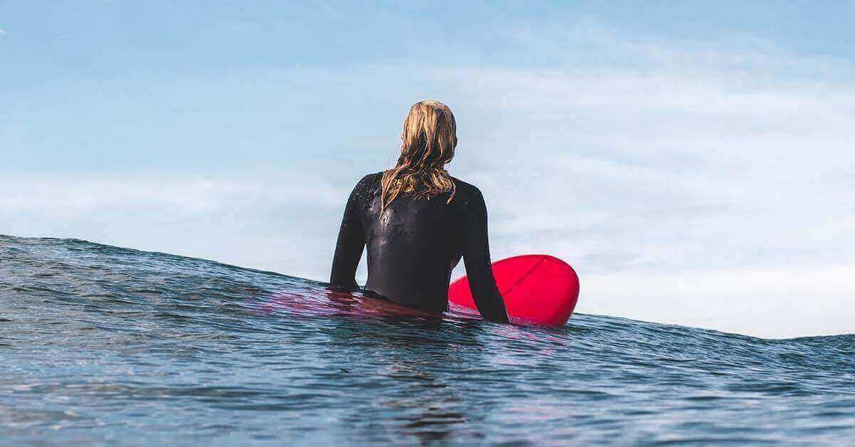 Female surfer on a board in the ocean.