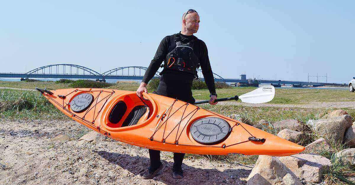 Kayaker in a wetsuit is prepared for cold-water kayaking.