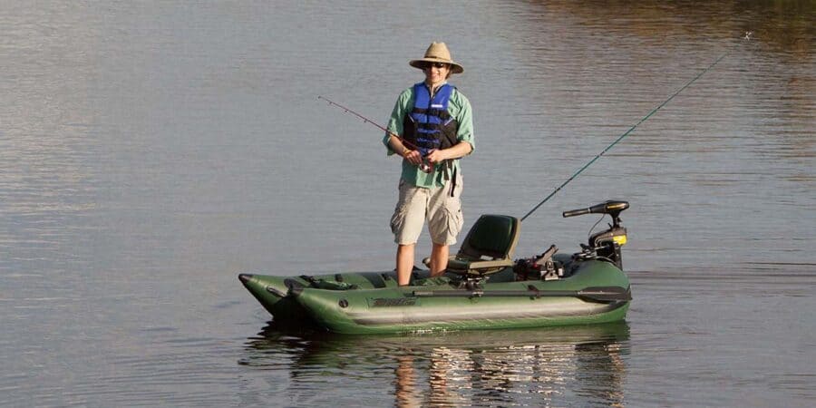 A fisherman standing to fish in a very stable Sea Eagle 285 Frameless Pontoon Boat Inflatable Fishing Boat.