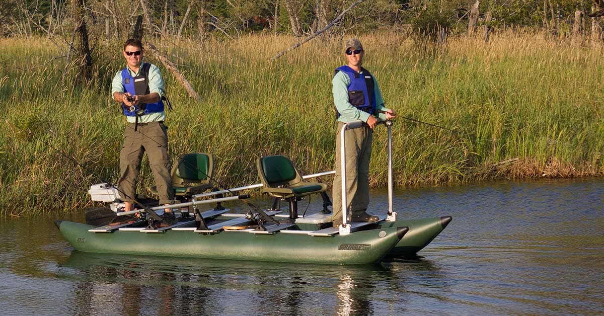 Two people standing and fishing from the 375fc FoldCat Inflatable Pontoon Boat.