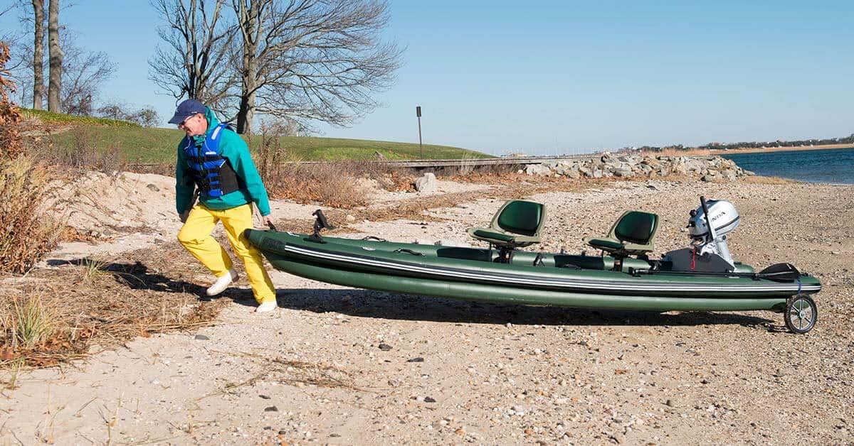 A fully loaded Sea Eagle FishSkiff 16 Inflatable Fishing Boat is easy to take to and from the put-in with the use of a cart.