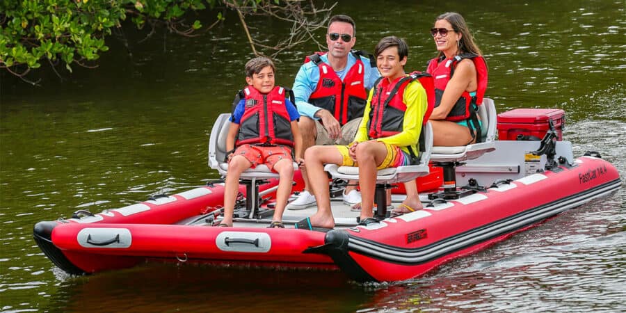 A family of four riding in comfort on a Sea Eagle FastCat14 Catamaran Inflatable Boat.
