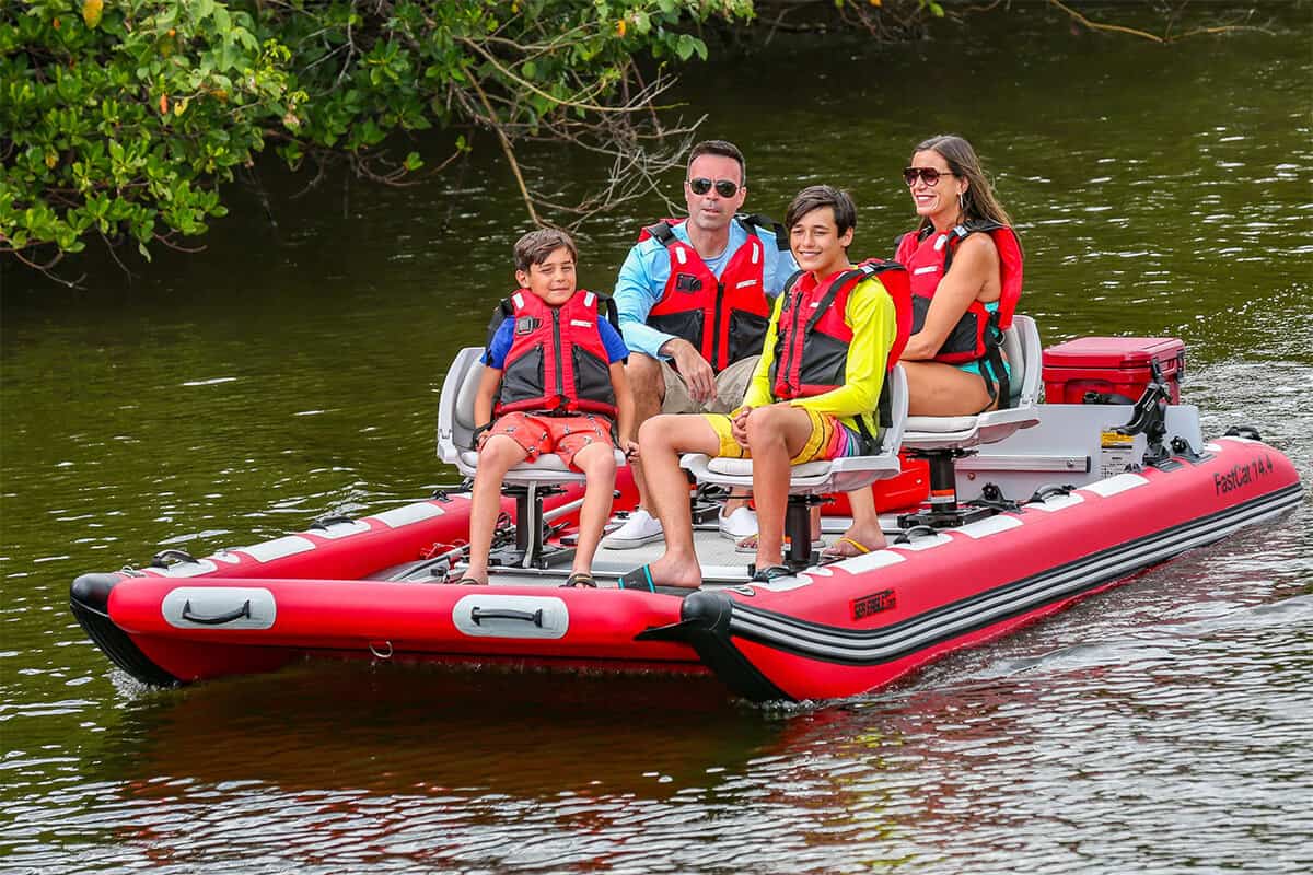 A family of four riding in comfort on a Sea Eagle FastCat14 Catamaran Inflatable Boat.