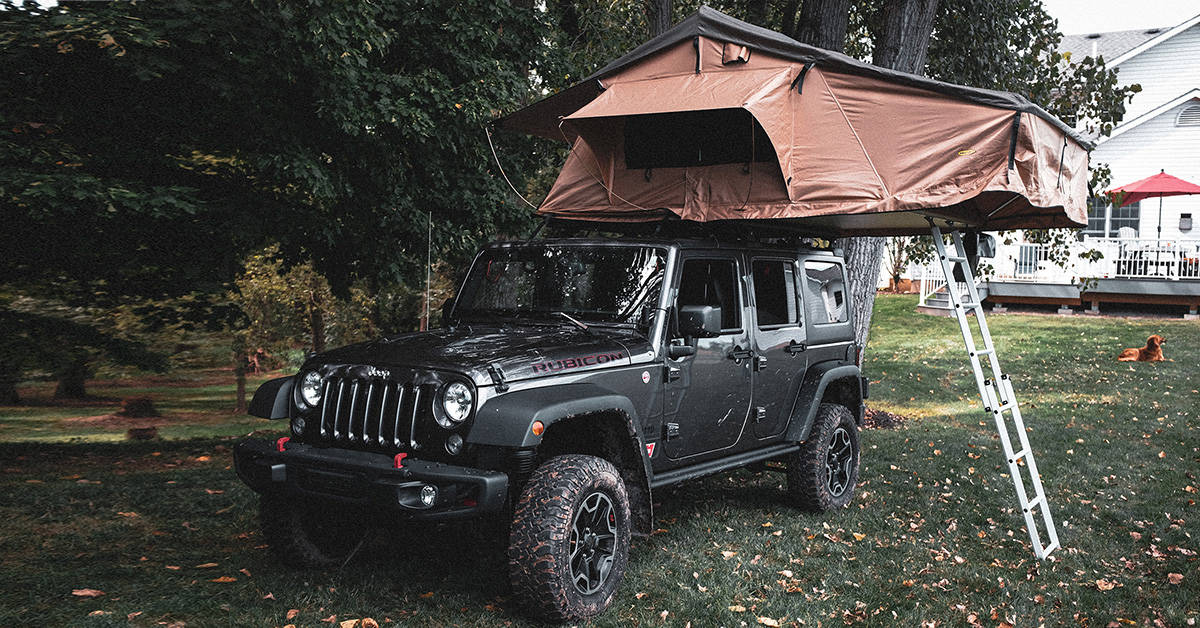 Soft shell roof-top tent set up on a 4-door Jeep Wrangler.