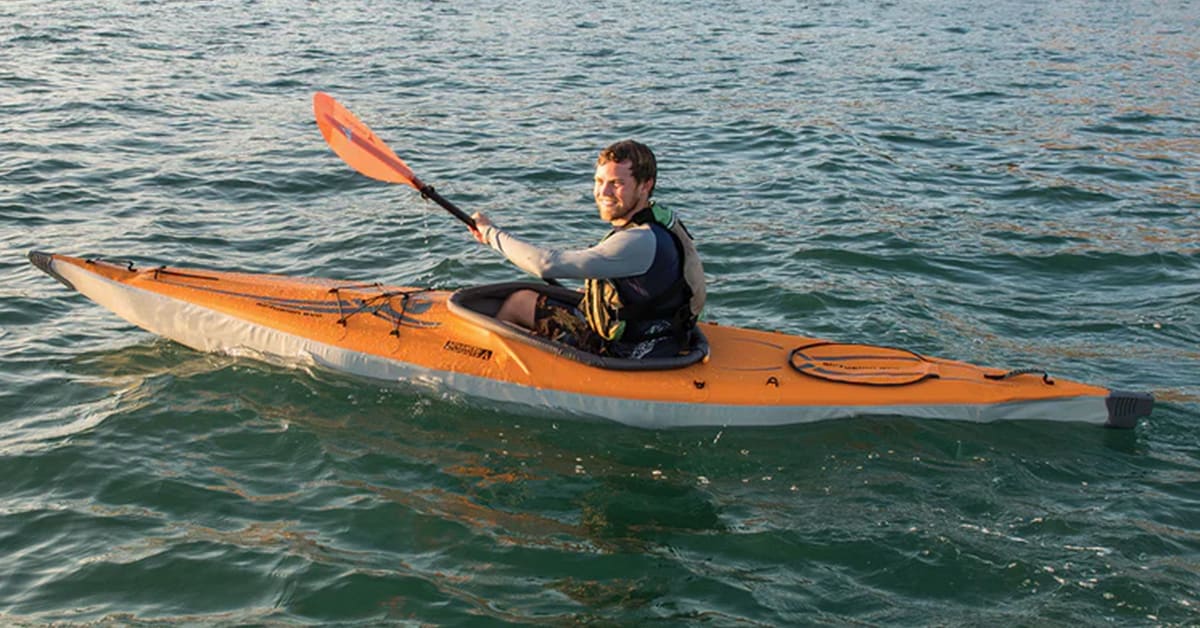 A man paddling an Advanced Elements AirFusion Evo Inflatable Kayak on the ocean.
