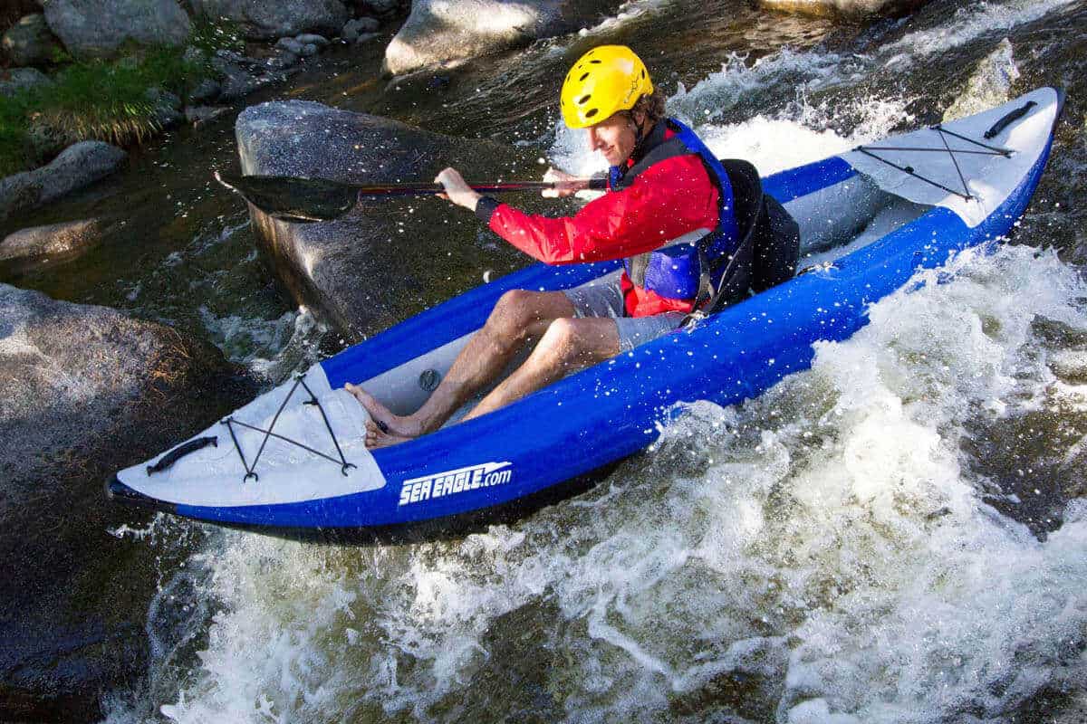 A man whitewater kayaking in a 300x Explorer.