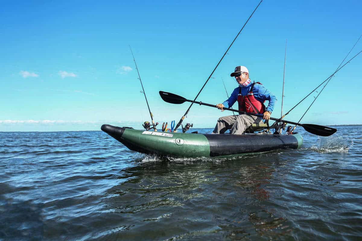 A fisherman paddles a Sea Eagle 350fx Fishing Explorer outfitted with a swivel seat.