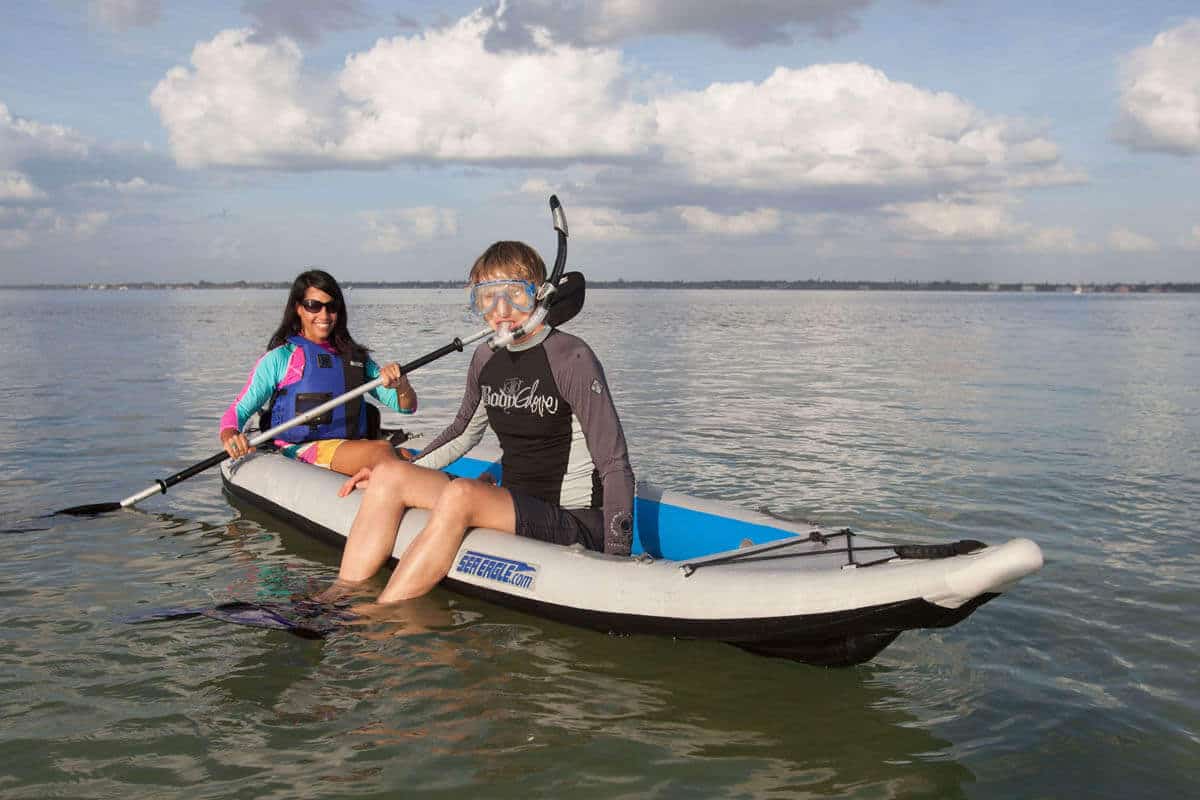 A kayaker and a snorkeler take advantage of calm waters in a 385 Fast Track.