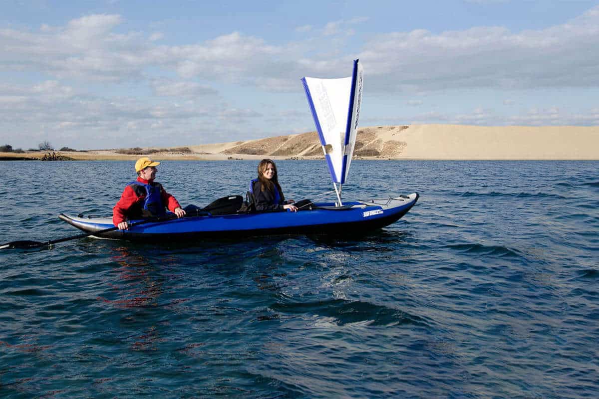 Two boaters in a Sea Eagle 420x with a sail.