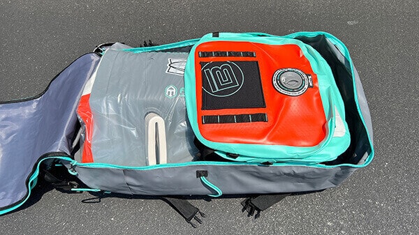 The kayak and gear inside the carry bag of a BOTE Zeppelin Aero 10'.