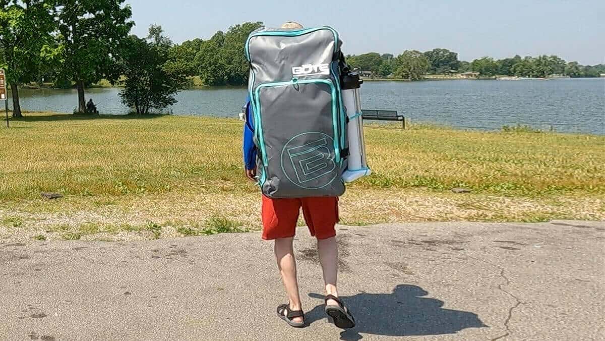 Carrying a BOTE Zeppelin Aero 10' and gear in a backpack.