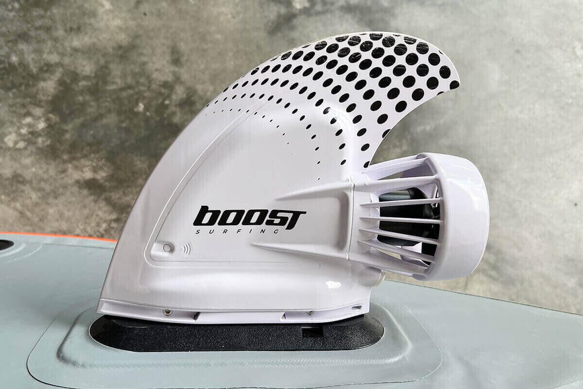 An electric Boost Surfing Fin mounted to the fin box of a Bote kayak.