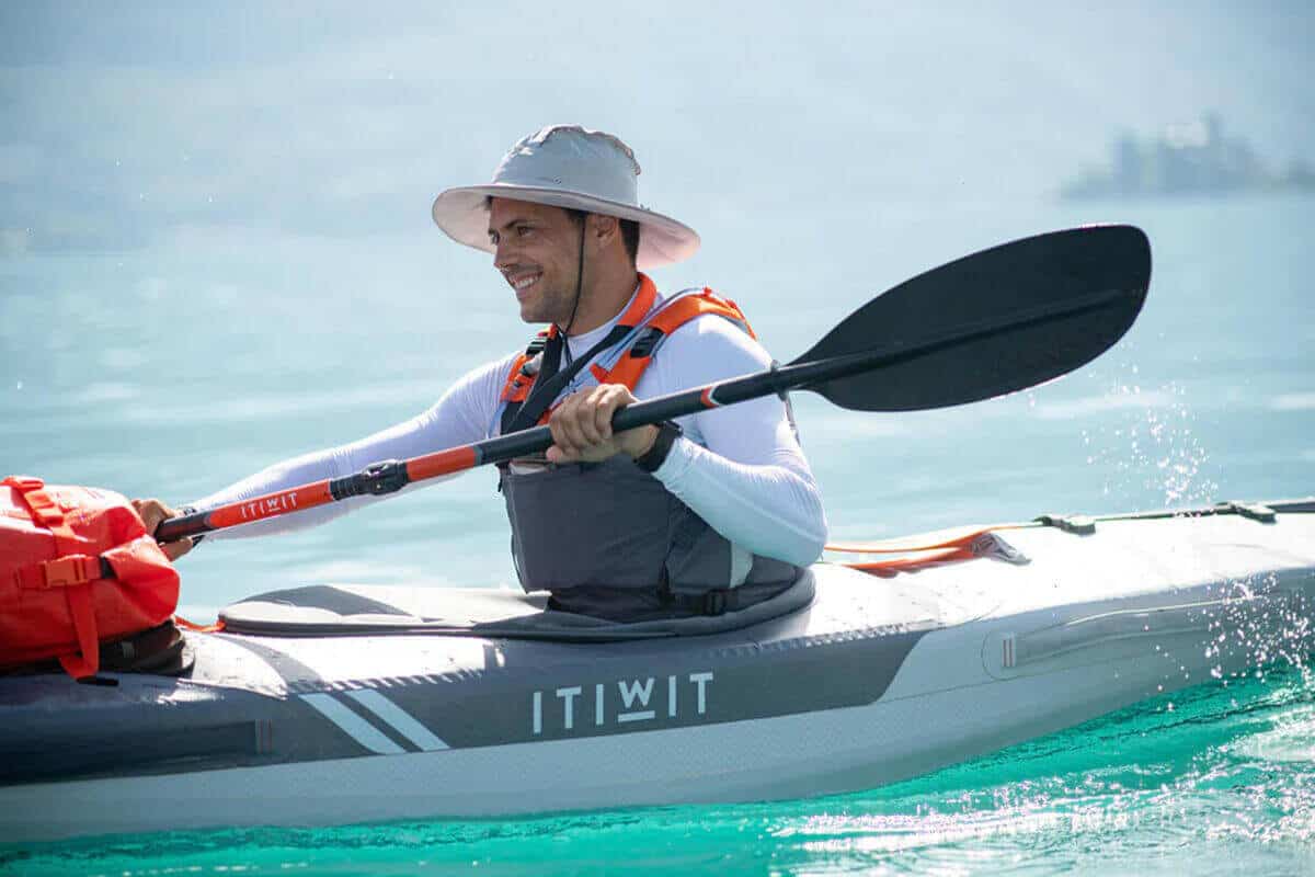 A Decathlon Itiwit X500 1-Person Inflatable Sit-In Kayak being paddled on the ocean.
