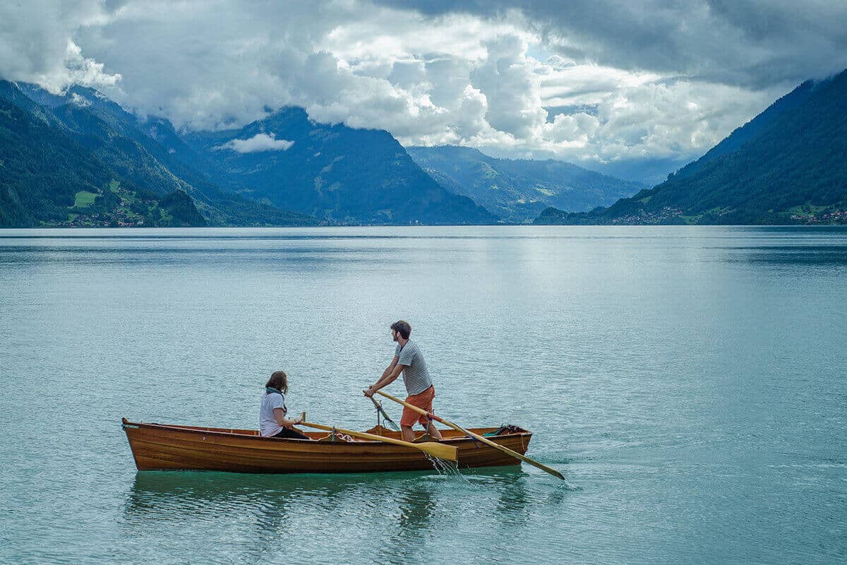 A couple rowing a boat together.